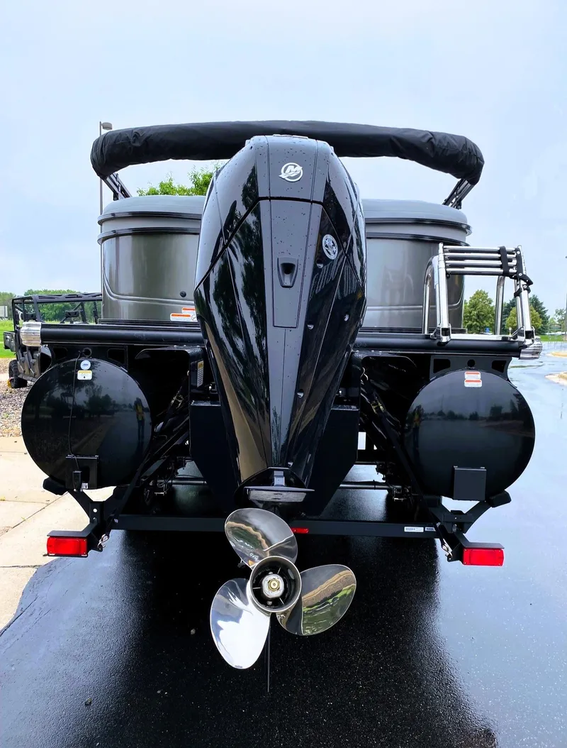 Slide: The Image of 2025 Regency 230 DL3 pontoon boat with powerful outboard motor, rear view. - 7