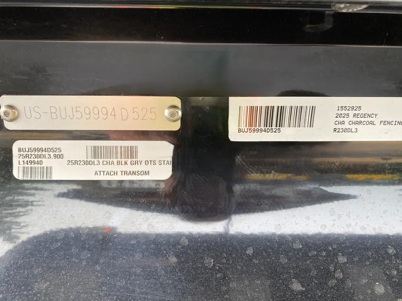 Slide: The Image of 2025 Regency 230 DL3 boat identification labels and barcodes on a dark surface. - 8