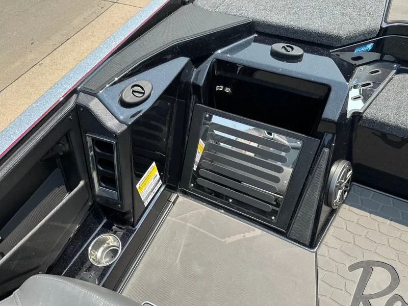 Slide: The Image of 2025 Ranger Z520R Cup-Equipped boat interior with storage compartments and cup holder. - 10