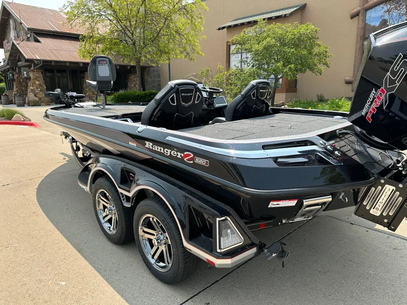 Slide: The Image of 2025 Ranger Z520R Cup-Equipped boat, sleek design, dual seats, parked outdoors. - 2