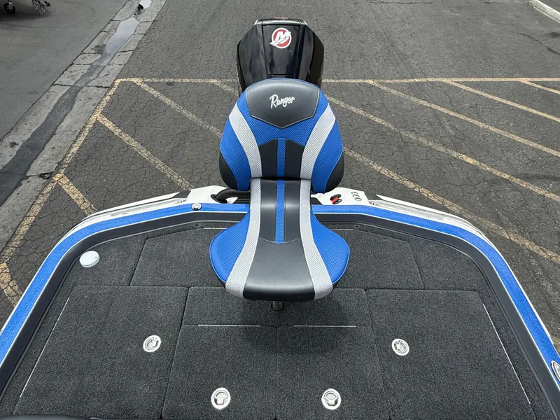 Slide: The Image of 2025 Ranger Z520R Cup-Equipped boat with blue and gray seating on a textured deck. - 8