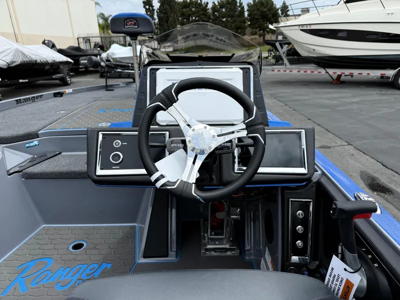 Slide: The Image of 2025 Ranger Z520R Cup-Equipped boat dashboard with steering wheel and controls. - 9