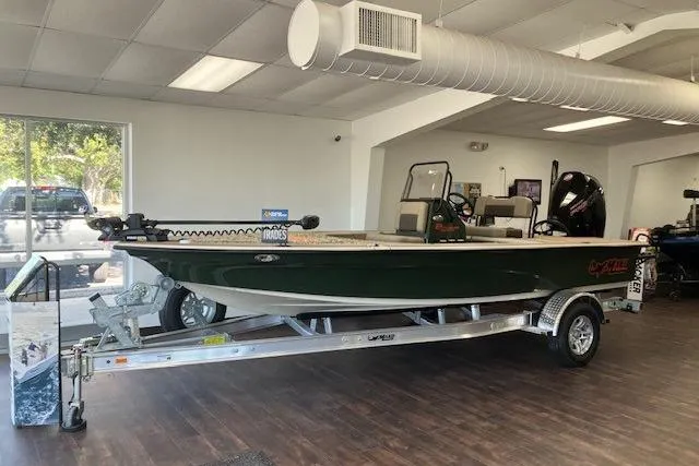 The Image of 2025 Mako 18 Pro Skiff Backwater Edition boat displayed indoors on a trailer. - 0