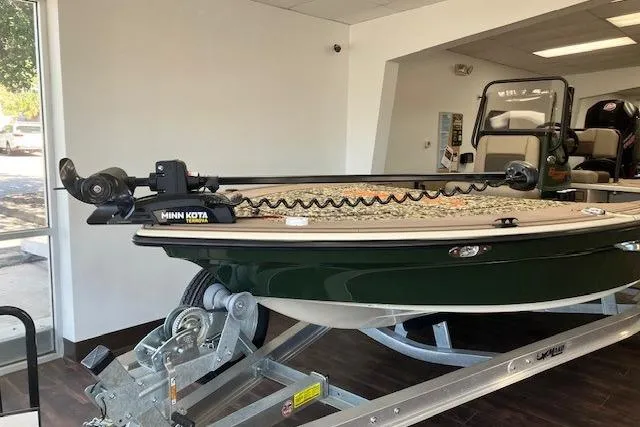 Slide: The Image of 2025 Mako 18 Pro Skiff Backwater Edition on trailer in showroom. - 1