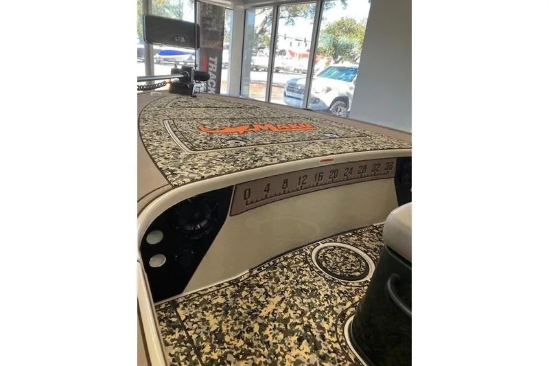 Slide: The Image of 2025 Mako 18 Pro Skiff Backwater Edition with camo deck and measurement scale. - 2