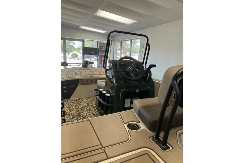 Slide: The Image of 2025 Mako 18 Pro Skiff Backwater Edition interior with steering console in showroom. - 5