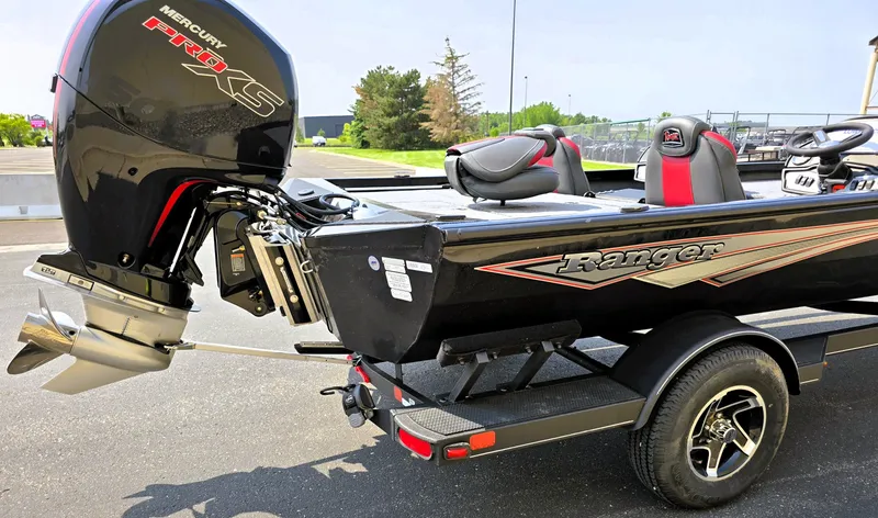 Slide: The Image of 2025 Ranger RT198P boat with Mercury engine on a trailer, parked outdoors. - 4