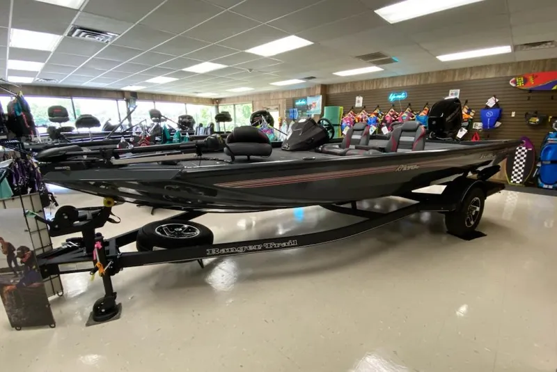 The Image of 2025 Ranger RT178C boat displayed in a showroom with accessories. - 0
