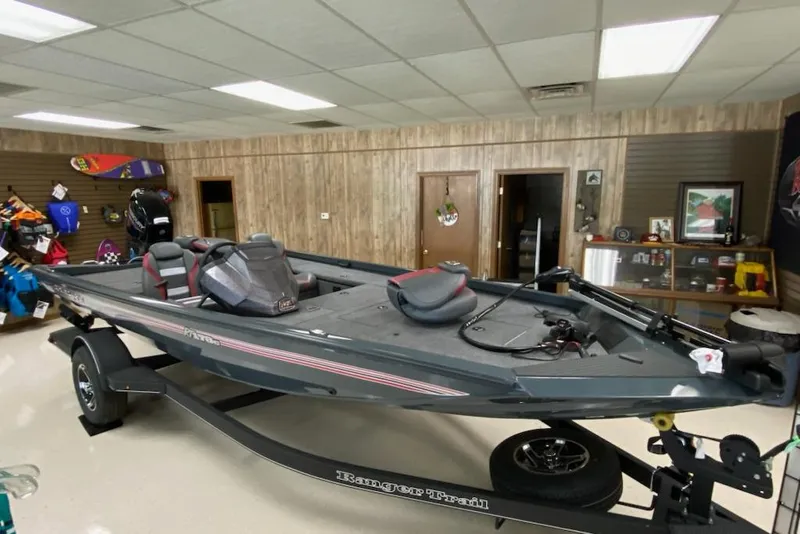 Slide: The Image of 2025 Ranger RT178C fishing boat displayed indoors on a trailer. - 1