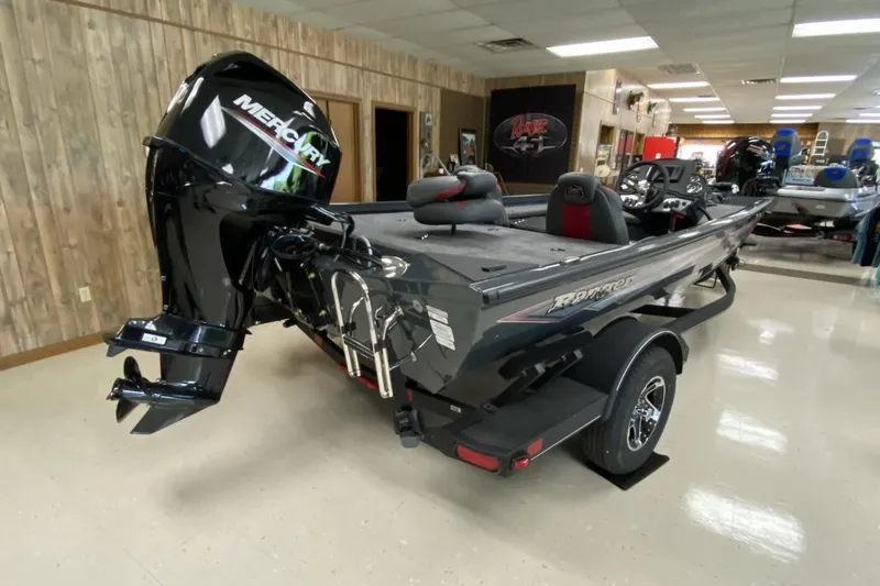 Slide: The Image of 2025 Ranger RT178C boat with Mercury engine displayed indoors. - 2