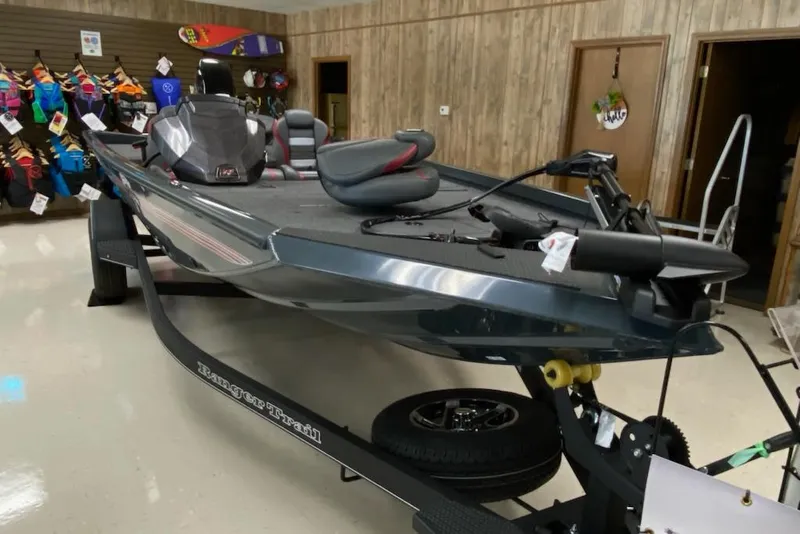 Slide: The Image of 2025 Ranger RT178C boat displayed indoors with accessories in the background. - 4