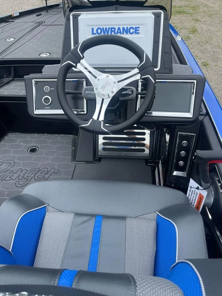 Slide: The Image of 2025 Ranger Z520R boat cockpit with Lowrance electronics and modern steering wheel. - 6