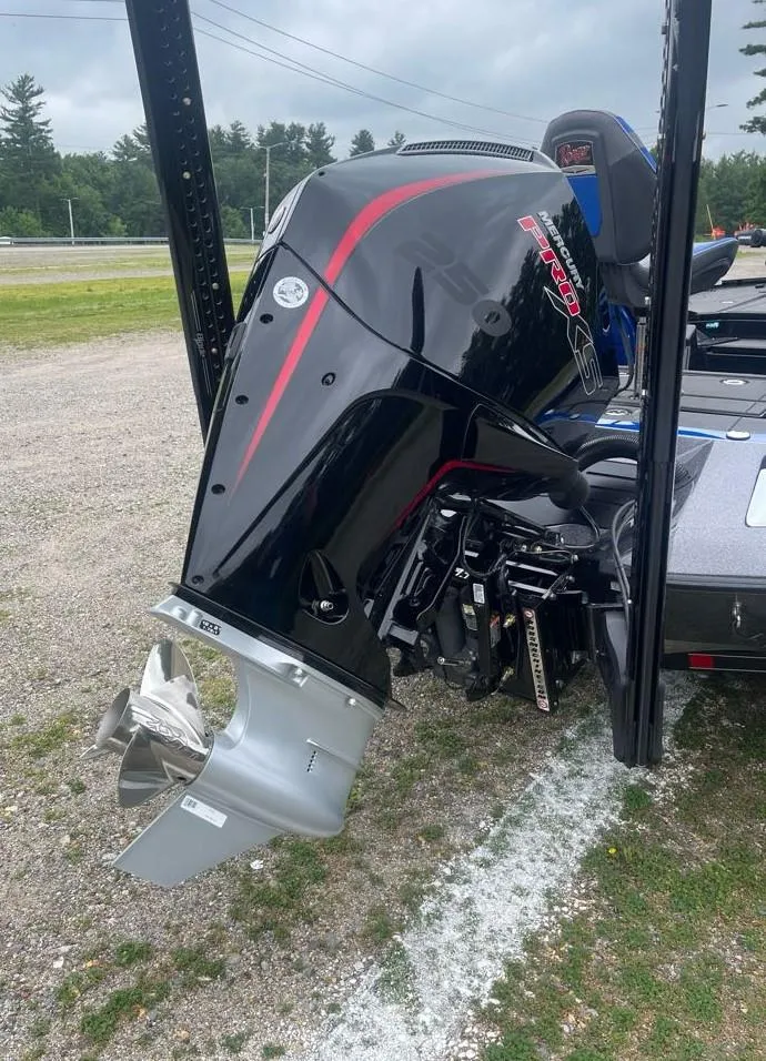 Slide: The Image of 2025 Ranger Z520R boat with a powerful outboard motor, parked on gravel. - 8