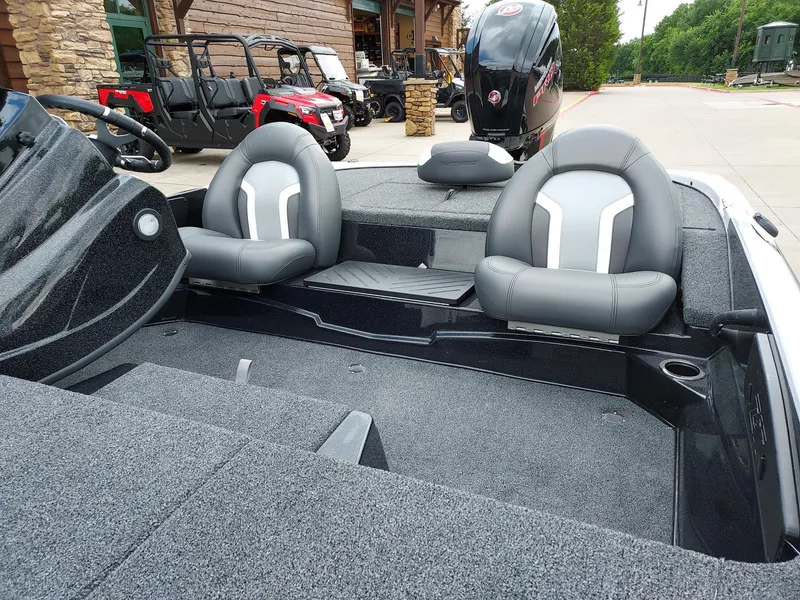 Slide: The Image of 2025 Nitro Z17 boat interior with gray seating and carpeted deck. - 2