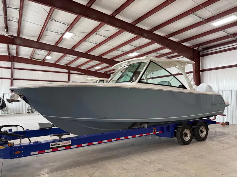 The Image of 2026 Sailfish 316 DC boat on trailer in indoor storage facility. - 0