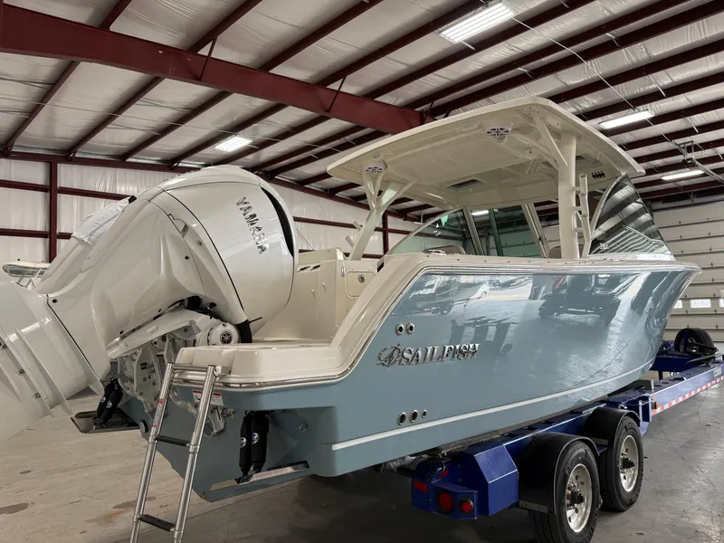 Slide: The Image of 2026 Sailfish 316 DC boat with Yamaha engine in a warehouse setting. - 2