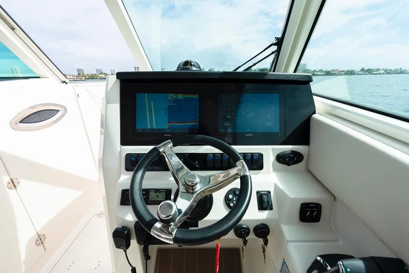 Slide: The Image of 2026 Sailfish 316 DC boat interior with sink, storage drawers, and mini fridge. - 24