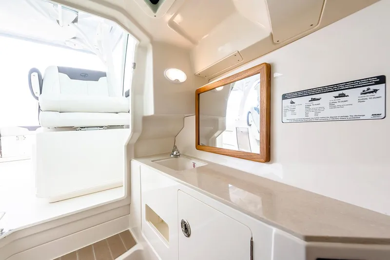 Slide: The Image of 2026 Sailfish 316 DC boat interior with seating and speakers in a showroom. - 29