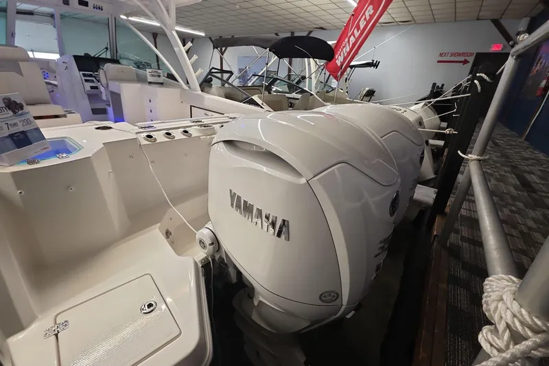 Slide: The Image of 2026 Sailfish 316 DC boat with Yamaha outboard engines displayed indoors. - 32