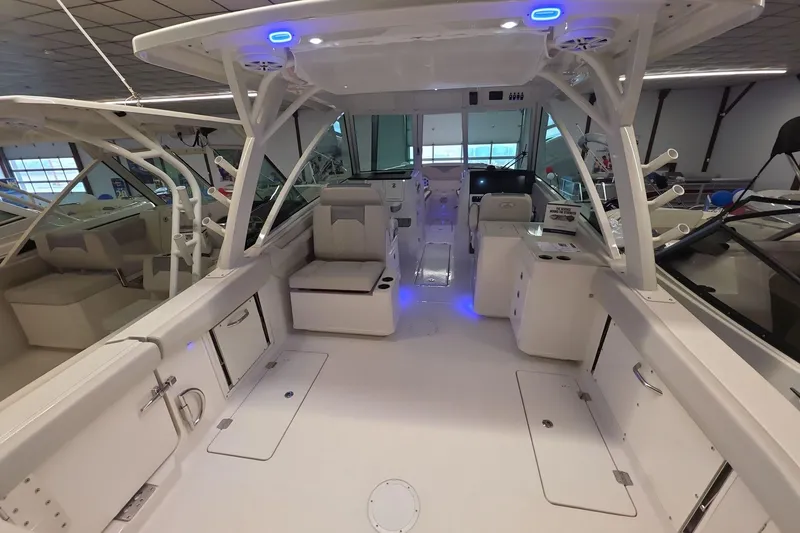 Slide: The Image of 2026 Sailfish 316 DC boat interior with modern seating and blue LED lighting. - 34