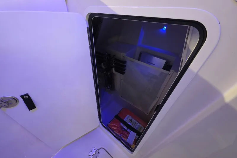 Slide: The Image of Open storage compartment on Sailfish 316 DC boat, featuring interior lighting and organized storage. - 37
