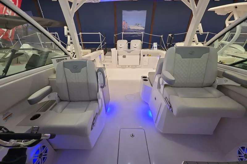 Slide: The Image of 2026 Sailfish 316 DC boat interior with luxurious seating and ambient blue lighting. - 38