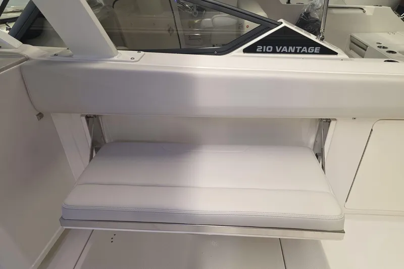 Slide: The Image of Interior view of 2026 Sailfish 316 DC boat with white seating and storage. - 44