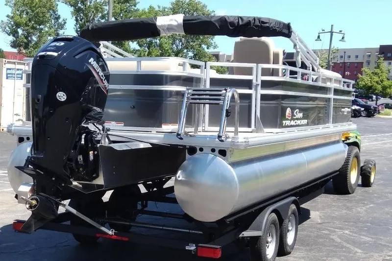 Slide: The Image of 2025 Sun Tracker Fishin' Barge 20 DLX pontoon boat on trailer, rear view. - 4