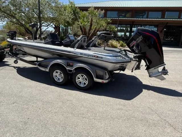 Slide: The Image of 2025 Ranger Z519R Cup-Equipped boat on trailer, parked outdoors near a building. - 3