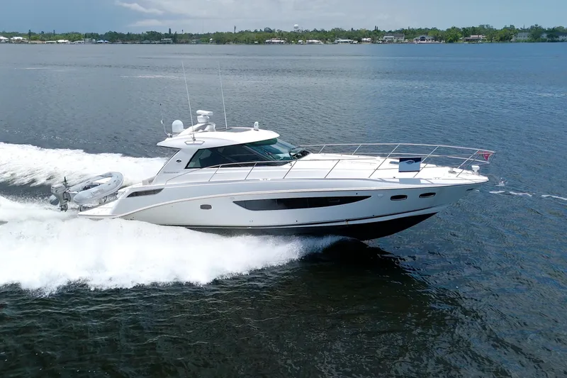 Slide: The Image of 2013 Sea Ray 450 Sundancer cruising on open water, showcasing sleek design and performance. - 0