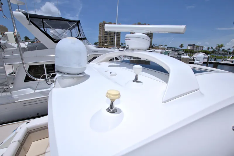 Slide: The Image of 2013 Sea Ray 450 Sundancer yacht docked at marina under clear blue sky. - 14