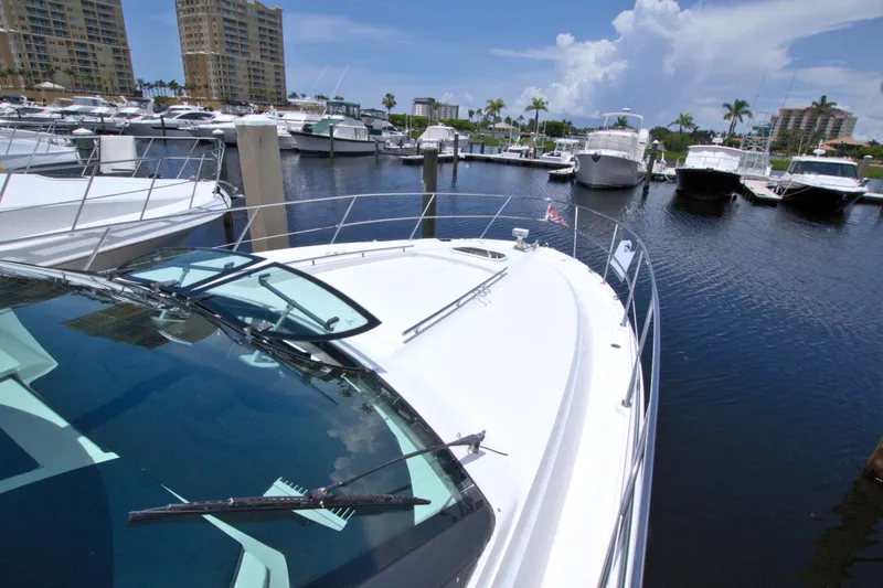 Slide: The Image of 2013 Sea Ray 450 Sundancer yacht docked in a marina with other boats. - 15