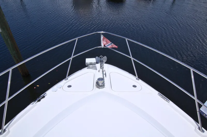 Slide: The Image of Bow view of 2013 Sea Ray 450 Sundancer yacht on calm water. - 16