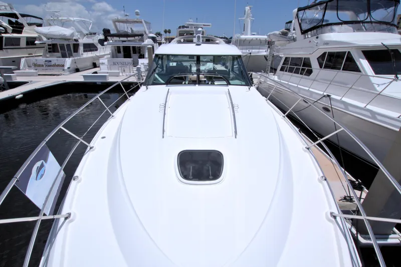 Slide: The Image of 2013 Sea Ray 450 Sundancer yacht docked among other boats in a marina. - 17