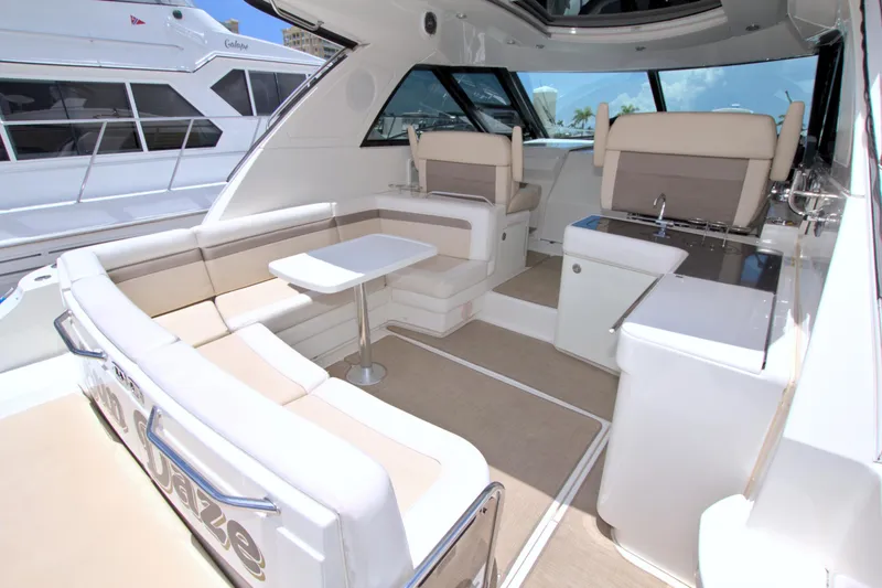 Slide: The Image of Luxurious interior of 2013 Sea Ray 450 Sundancer yacht with seating and table. - 19