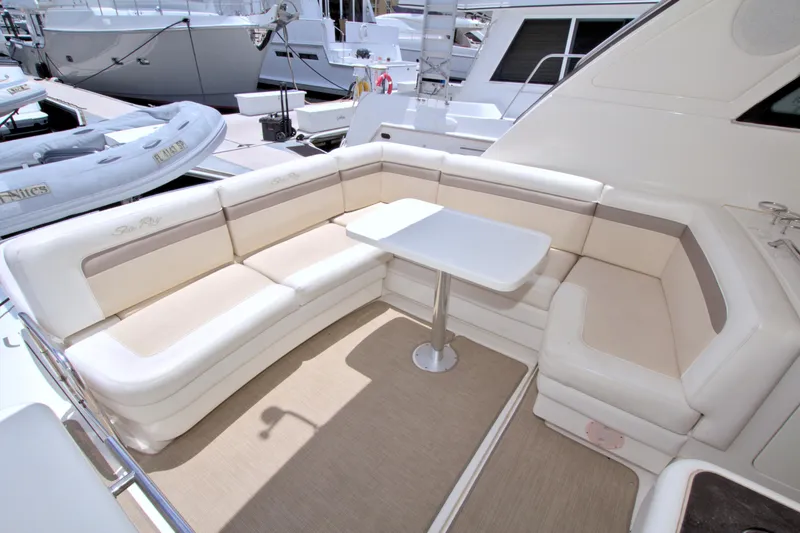 Slide: The Image of Luxurious seating area on 2013 Sea Ray 450 Sundancer yacht with white cushions and table. - 21
