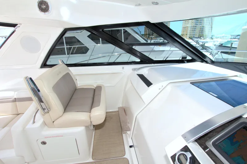 Slide: The Image of Interior of 2013 Sea Ray 450 Sundancer yacht with beige seating and modern dashboard. - 22