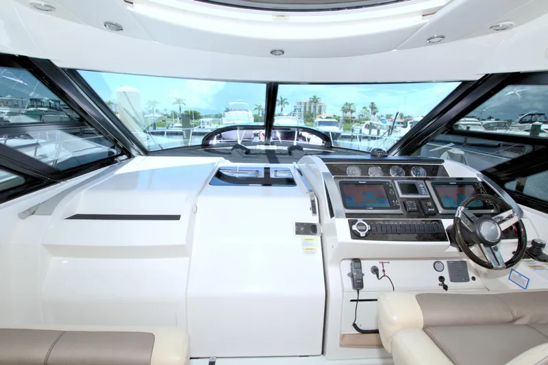 Slide: The Image of Helm of 2013 Sea Ray 450 Sundancer yacht with modern navigation equipment and luxurious seating. - 23