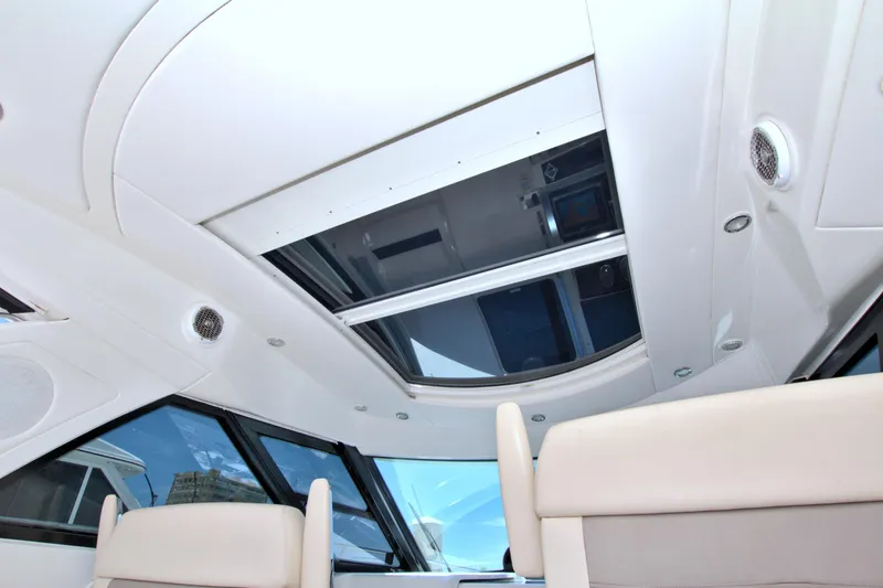 Slide: The Image of Interior view of 2013 Sea Ray 450 Sundancer yacht with sunroof and seating. - 26