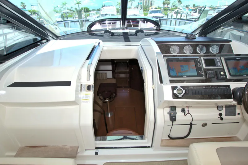 Slide: The Image of Interior cockpit of 2013 Sea Ray 450 Sundancer with navigation controls and seating. - 27