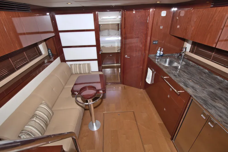 Slide: The Image of Luxurious interior of 2013 Sea Ray 450 Sundancer yacht with modern kitchen and seating area. - 29