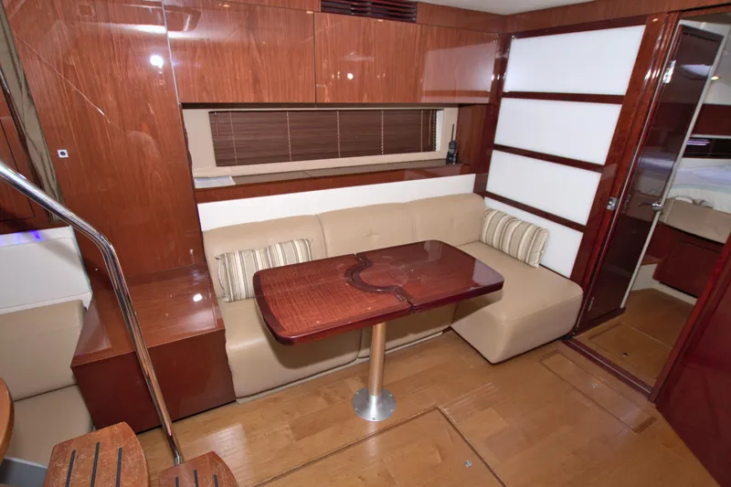 Slide: The Image of Luxurious interior of 2013 Sea Ray 450 Sundancer yacht with wooden finishes and cozy seating. - 30