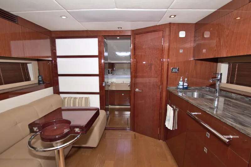 Slide: The Image of Luxurious interior of 2013 Sea Ray 450 Sundancer yacht with wood finishes and modern amenities. - 31