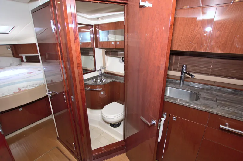 Slide: The Image of Luxurious interior of 2013 Sea Ray 450 Sundancer yacht with wood finishes and modern amenities. - 32
