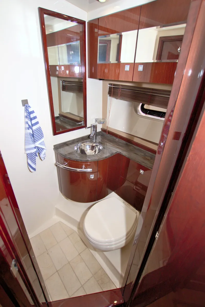Slide: The Image of Luxurious bathroom in 2013 Sea Ray 450 Sundancer yacht with wood cabinetry and modern fixtures. - 33