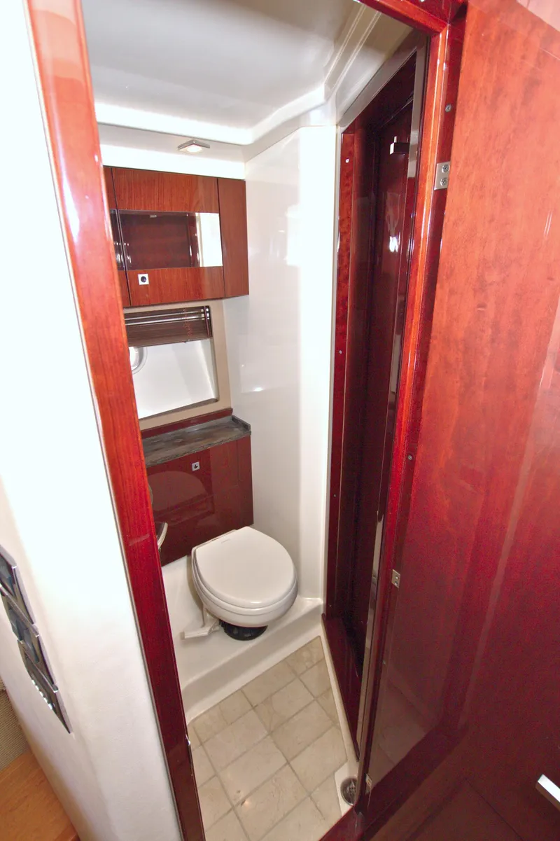 Slide: The Image of Luxurious bathroom in 2013 Sea Ray 450 Sundancer yacht with wood accents and modern fixtures. - 34