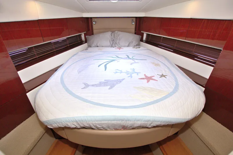 Slide: The Image of Luxurious bedroom interior of 2013 Sea Ray 450 Sundancer yacht with nautical-themed bedding. - 37
