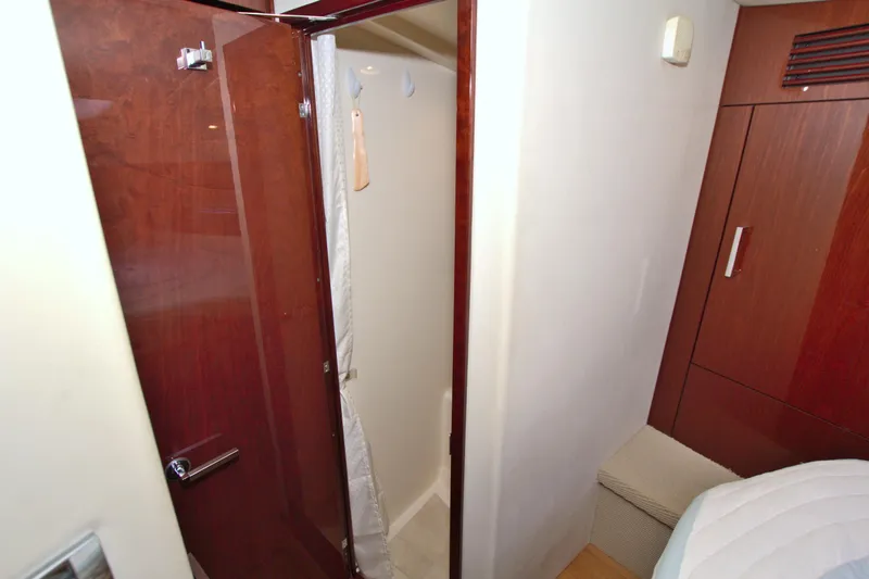 Slide: The Image of Interior of 2013 Sea Ray 450 Sundancer yacht, featuring a wooden door and compact shower area. - 40