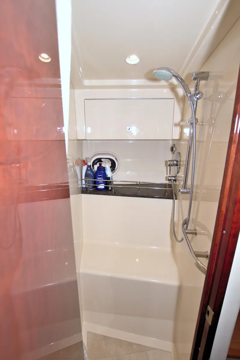 Slide: The Image of Shower area in 2013 Sea Ray 450 Sundancer yacht, featuring modern fixtures and storage space. - 41