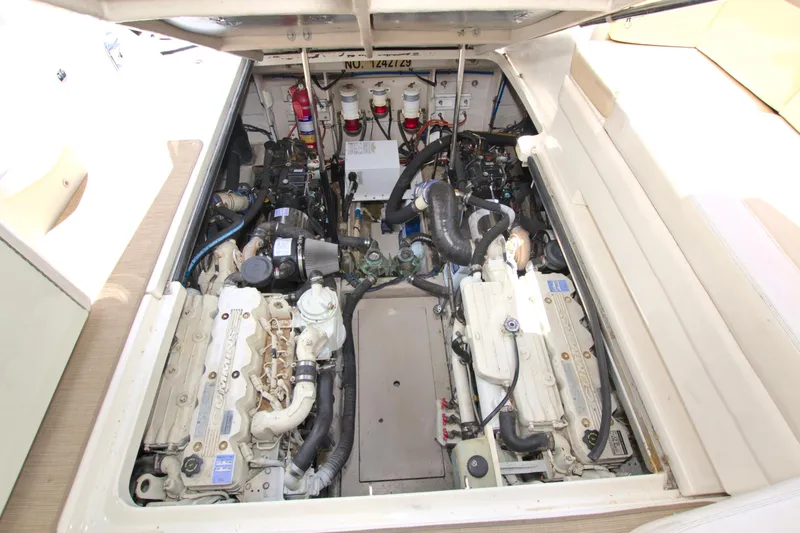 Slide: The Image of Engine compartment of a 2013 Sea Ray 450 Sundancer, showcasing dual engines and mechanical components. - 46